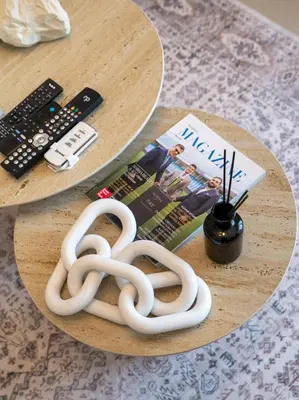 two white rope knots on a table with a remote control at STAY BY LATINEM Luxury 1BR Holiday Home CVR A2910 Near Burj Khalifa in Dubai