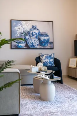 a living room with blue and white vases on the wall at STAY BY LATINEM Luxury 1BR Holiday Home CVR A2910 Near Burj Khalifa in Dubai