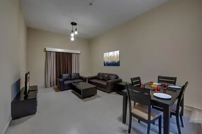a living room with a couch and a table at City Stay Residences - Serviced Apartments DIP in Dubai
