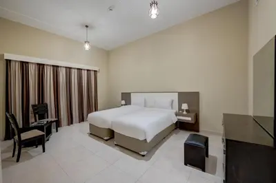 a hotel room with a bed and a television at City Stay Residences - Serviced Apartments DIP in Dubai