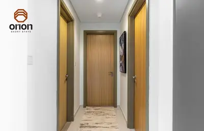 a hallway with two doors and a carpet at Paramount 2 Bed Apt, Roof Top Bar and Pool overlooking Burj, Triple Balcony, Fully Equipped, Free Toiletries, Full Kitchen, 2 and half Bathrooms, Ground Floor Supermarket, Influencers Haven, Sunrise and Sunset Views over the Sea From All Balcony in Dubai