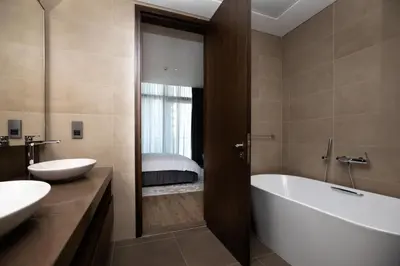 a bathroom with a tub and a sink and a bath tub at LUXURY 1 BR Apartment at Marina Gate Jumeirah Living in Dubai