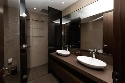 a bathroom with two sinks and a large mirror at LUXURY 1 BR Apartment at Marina Gate Jumeirah Living in Dubai