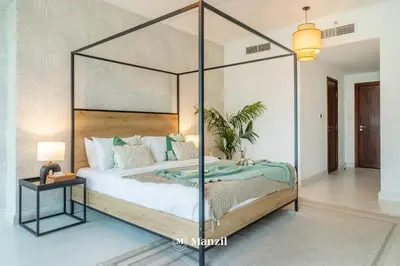 a bedroom with a canopy bed in a room at Manzil - Luxury 3BR Villa w/ maid room, Full Burj & Fountain view in Dubai