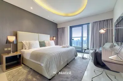 a bedroom with a large bed and a large window at Manzil - Ultra Luxury 1BR apartment Paramount Tower with Burj Khalifa and Downtown Views in Dubai