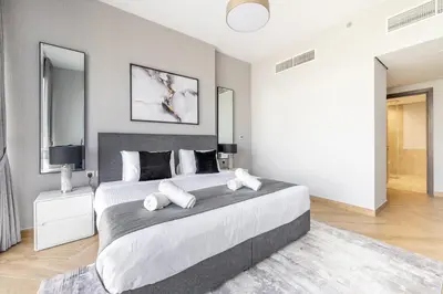 a bedroom with a large bed with two white pillows at Ultra Luxury Wasl 1 Residences Zabeel Park in Dubai