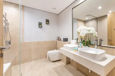 a bathroom with two sinks and a shower at Ultra Luxury Wasl 1 Residences Zabeel Park in Dubai