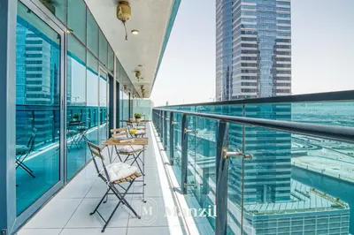 a balcony with a table and chairs on a building at Elegant 3BR in a Prime Location Near Metro, Business Bay in Dubai