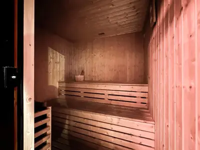 a wooden sauna with a wooden floor and wooden walls at Trophy - Urban Oasis Suite in Dubai