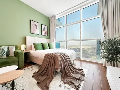 a bedroom with a bed and a large window at Trophy - Urban Oasis Suite in Dubai