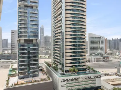 two tall skyscrapers in a city with buildings at Elegant Apartment Amidst Vibrant Area With Balcony in Dubai