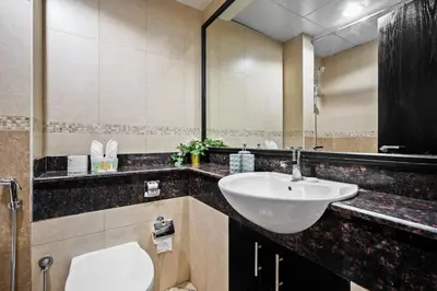 a bathroom with a sink and a toilet at Cozy JLT Studio Lakeview Pool Metro Access in Dubai