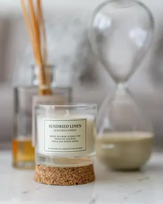 a candle sitting on top of a counter with a clock at GuestReady - Beachfront heaven with stunning views in Dubai