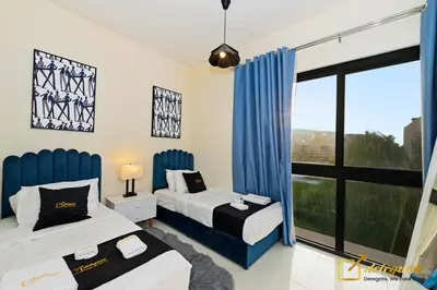 a bedroom with two beds and a large window at Dubai Private Pool villa Damac Hills 2 deleguest in Dubai