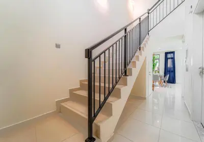 a staircase in a home with white walls and white tile floors at Dubai Private Pool villa Damac Hills 2 deleguest in Dubai