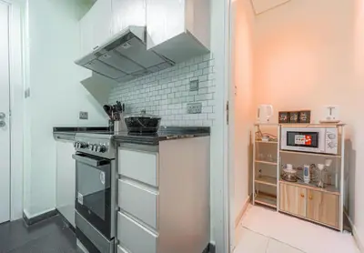a small kitchen with a stove and a sink at Dubai Private Pool villa Damac Hills 2 deleguest in Dubai