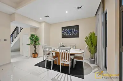 a dining room with a table and chairs at Dubai Private Pool villa Damac Hills 2 deleguest in Dubai