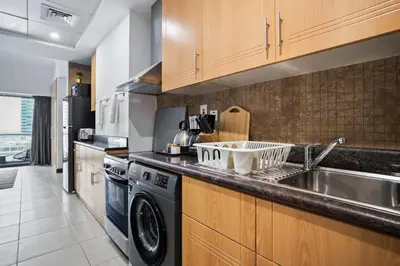 a kitchen with a sink and a dishwasher at Luxury JLT Studio Lakeview Pool & Marina Walk in Dubai