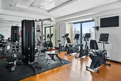 a gym with several treadmills and exercise bikes at Luxury JLT Studio Lakeview Pool & Marina Walk in Dubai