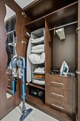 a room with a closet with a camera in it at Furnished studio in Arch Tower, JLT near metro in Dubai
