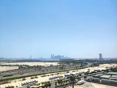 a view of a highway with a city in the background at Sleek and Stylish 2-Bedroom Apartment in Dubai
