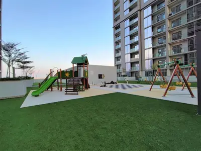 a park with a playground with a slide at Sleek and Stylish 2-Bedroom Apartment in Dubai