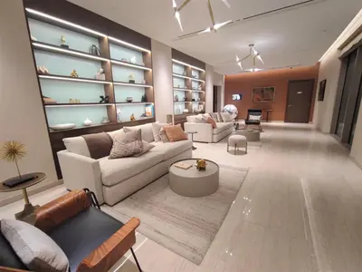 a living room with two couches and a table at New 1 bedroom in Sobha Hartland in Dubai