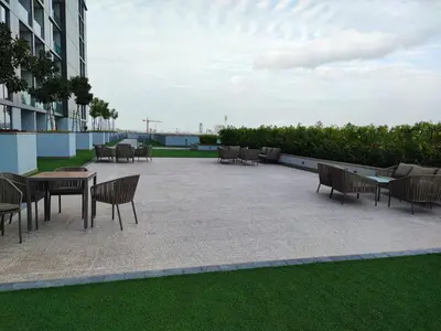 a patio with tables and chairs on a building at New 1 bedroom in Sobha Hartland in Dubai