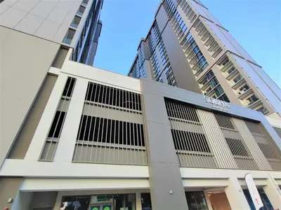 a building in front of some tall buildings at New 1 bedroom in Sobha Hartland in Dubai