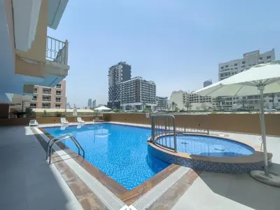a large swimming pool on top of a building at Spacious Serene Studio Retreat in JVC by Suiteable in Dubai