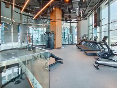 a gym with rows of exercise bikes and treadmills at Stylish studio next to canal in Dubai