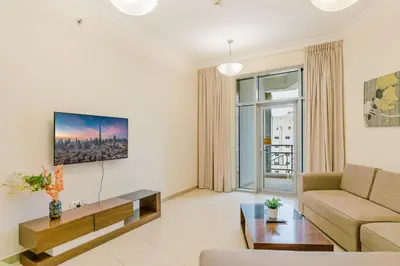 a living room with a couch and a table at RH- Spacious, Stylish, 01BR near Mall of Emirates in Dubai