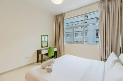 a hotel room with a bed and a window at RH- Spacious, Stylish, 01BR near Mall of Emirates in Dubai