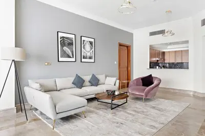 a living room with a couch and a table at StoneTree - Fairmont South 2 BR - Near Beach in Dubai