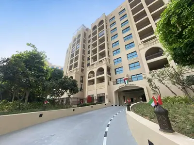 an empty street in front of a large building at StoneTree - Fairmont South 2 BR - Near Beach in Dubai