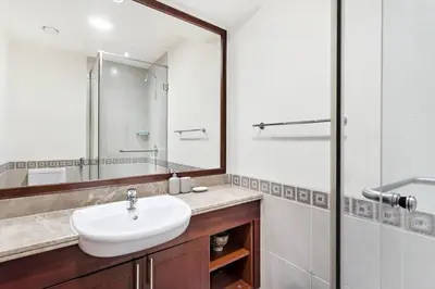 a bathroom with a sink and a mirror at StoneTree - Fairmont South 2 BR - Near Beach in Dubai