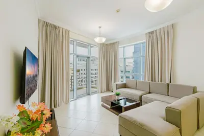 a living room with a couch and a table at RH-Prime Location , Spacious 1 Bedroom near Mall of the Emirates in Dubai