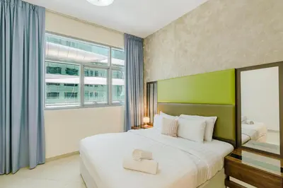 a bedroom with a large bed and a window at RH- Huge, Comfortable 01 BR Apartment in Barsha1 in Dubai