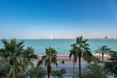 a view of the beach and palm trees at GuestReady - A Glimpse of Burj Al Arab in Dubai