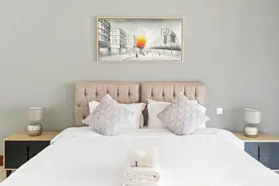 a bedroom with a large white bed with white pillows at StoneTree - Golden Mile 5 2BR - Near Nakhil Mall in Dubai