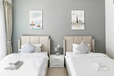 two beds sitting next to each other in a bedroom at StoneTree - Golden Mile 5 2BR - Near Nakhil Mall in Dubai