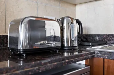 two toasters sitting on top of a kitchen counter at StoneTree - Golden Mile 4 2 BR - Supreme Residences in Dubai