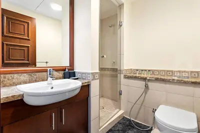 a bathroom with a sink and a toilet and a shower at StoneTree - Golden Mile 4 2 BR - Supreme Residences in Dubai