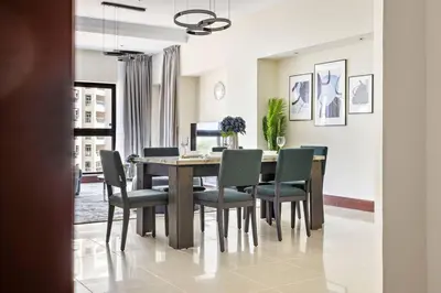 a dining room with a table and chairs at StoneTree - Golden Mile 4 2 BR - Supreme Residences in Dubai