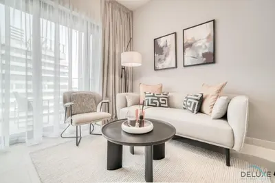 a living room with a couch and a table at Polished 1BR at Binghatti Creek Al Jadaf by Deluxe Holiday Homes in Dubai