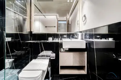 a bathroom with a sink and a toilet and a mirror at Polished 1BR at Binghatti Creek Al Jadaf by Deluxe Holiday Homes in Dubai