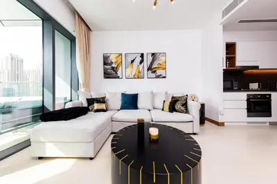 a living room with a couch and a table at BRAND-NEW 1 Bedroom with full Marina View in Dubai