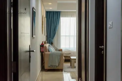 a room with a couch and a bed and a window at Mira Holiday Homes - Beautiful Studio in Living Legends in Dubai