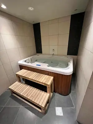 a jacuzzi tub with a bench in a bathroom at Marina Residences 2BR: Seaside in Palm Jumeirah in Dubai