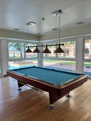 a pool table in a living room with windows at Marina Residences 2BR: Seaside in Palm Jumeirah in Dubai